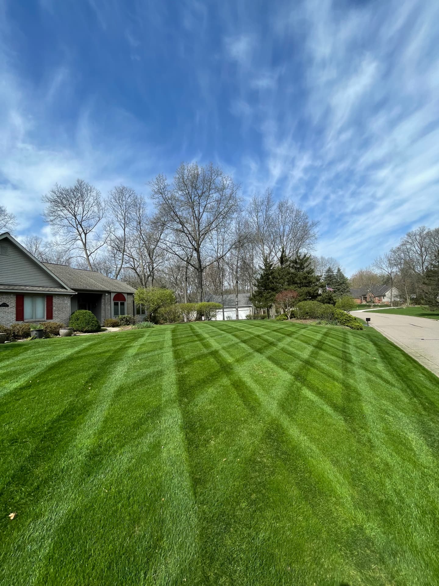 Freshly striped lawn mowed by GOAT Lawn & Outdoor Services in Brighton, MI